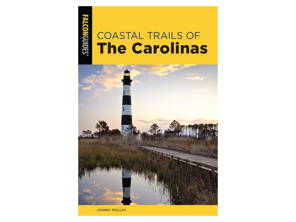 Book cover of 'Coastal Trails of The Carolinas' with a lighthouse and coastal path.