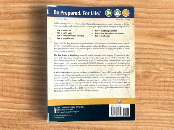 Back cover of a book titled 'Be Prepared. For Life.' on a wooden surface